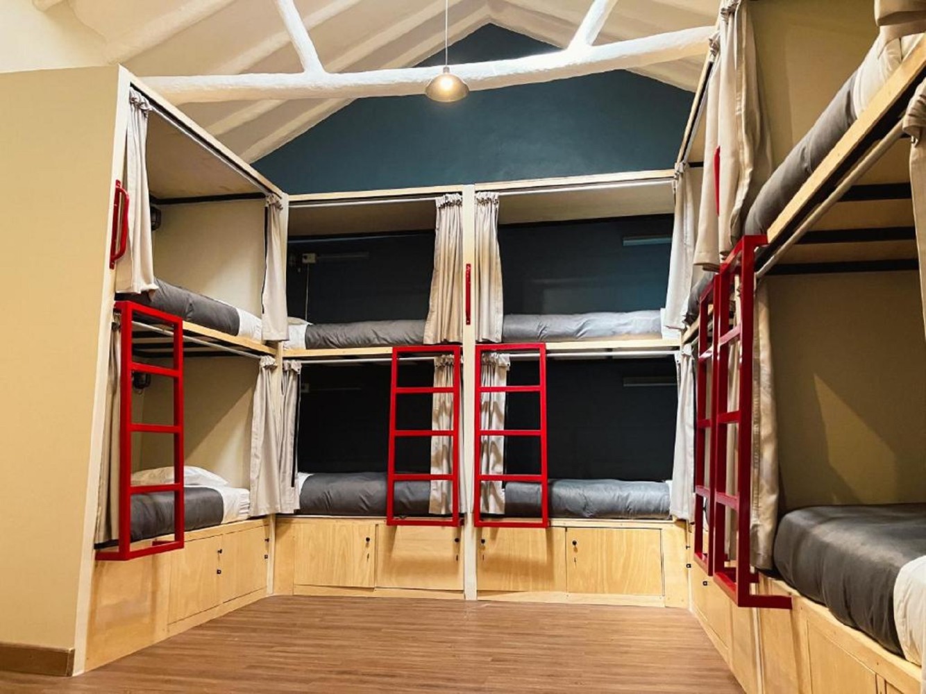 a room with bunk beds and wood flooring